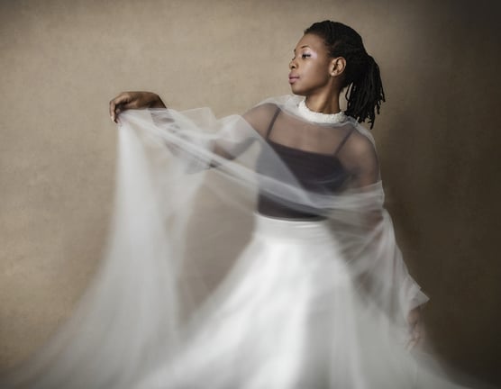 Photograph of a dancing woman with a veil