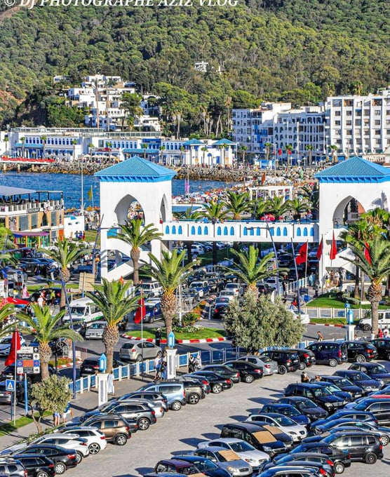 morocco al mediaq a parking lot with cars parked in front of a mountain