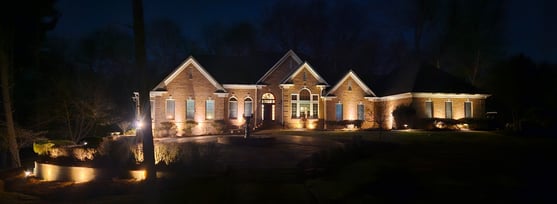 Residential home at night with expert landscape lighting by Green Light Electrical Contractors