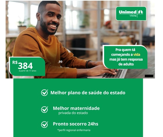 a man sitting at a laptop computer with a green screen