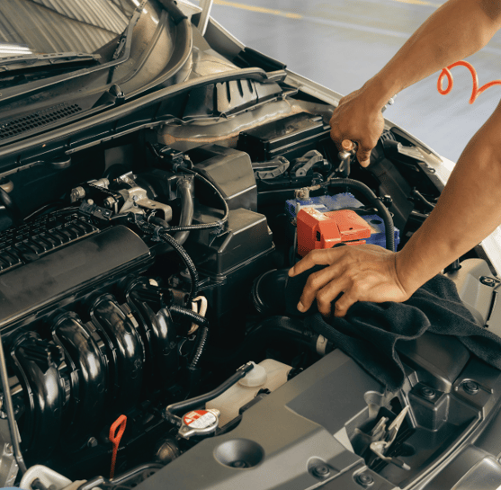 Mechanic connecting electrical wires under the hood for car repairs and diagnostics.