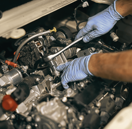 Mechanic tightening a car part during maintenance to ensure optimal vehicle performance