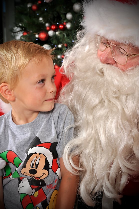 Peter Pickering's endearing photo of boy in a Mickey Mouse tee shirt gazing enquiringly at Santa