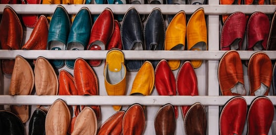 Image showing a bunch of different colour shoes that are sitting on a shelf