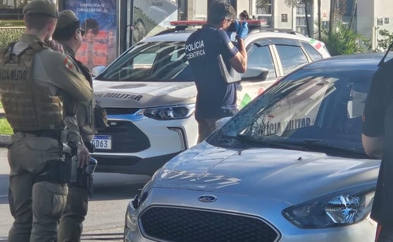 a police officer standing in front of a car