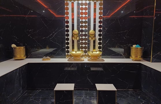 a bathroom with a mirror and a gold statue