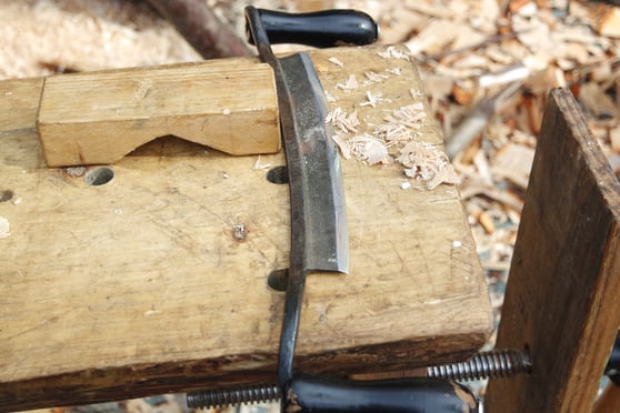 a drawknife on a wooden table