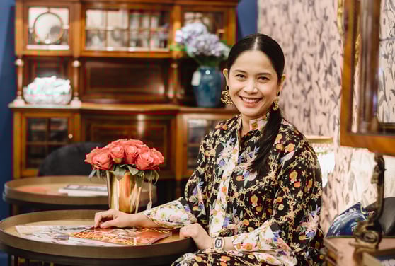 a woman sitting at a table with a tray of food