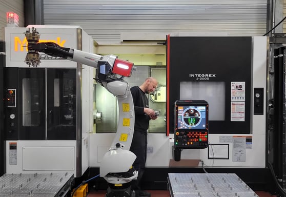 a man in a black suit and a robot