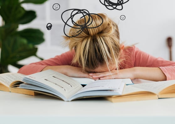 a woman with her head in her hands, with a book and a book on