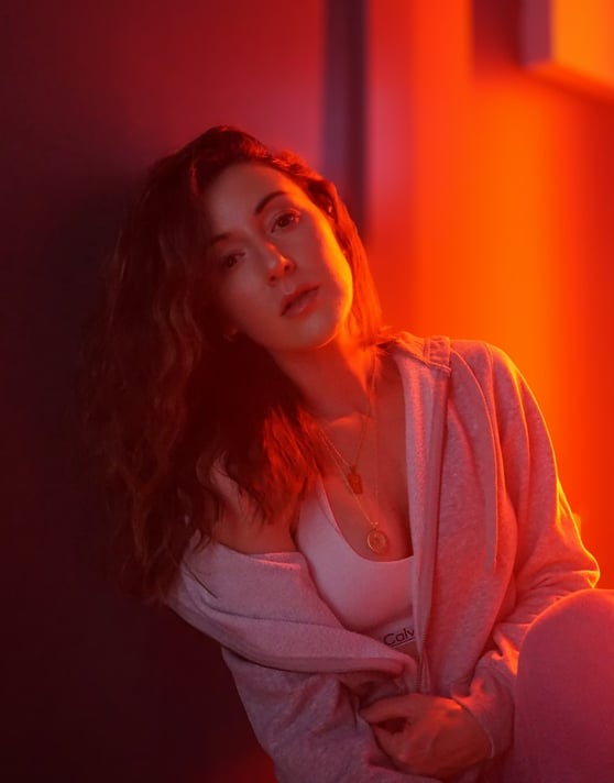 a woman sitting on a bench in a room