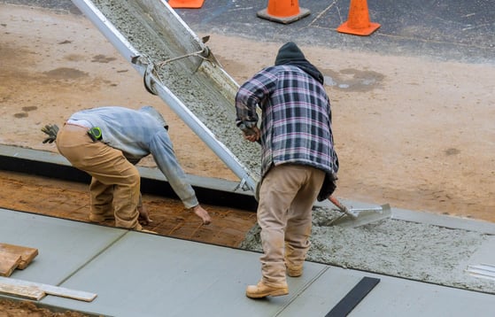 two men working on a concrete slab