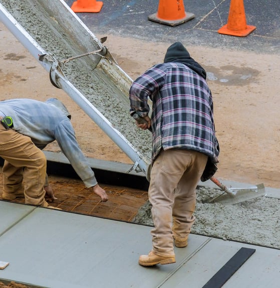 two men working on a concrete slab