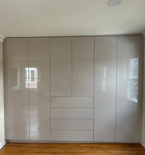a room with a wooden floor and a white cupboard