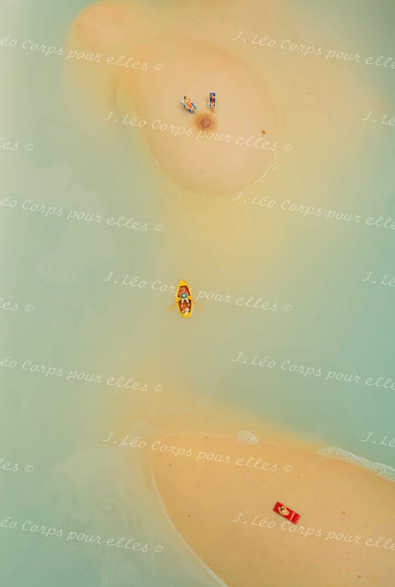 a couple of people are sitting on a beach