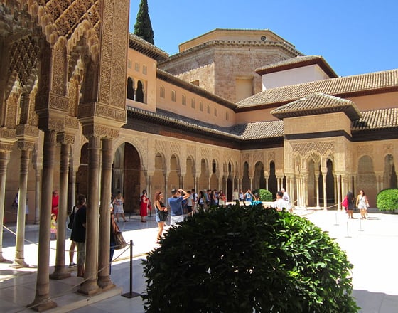 morocco fes a courtyard with a lot of people walking around