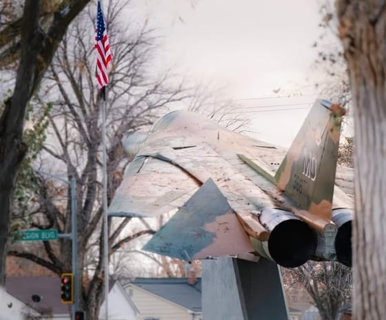 Jet display in Mountain Home Idaho with an American flag.