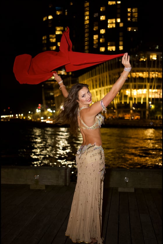 Red veil raised high over the harbour at night