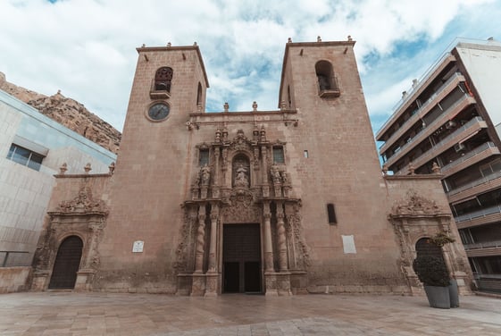 a large church with a clock - Basilica of St Mary of Alicante