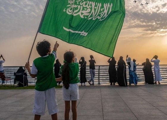a couple of people holding a green flag