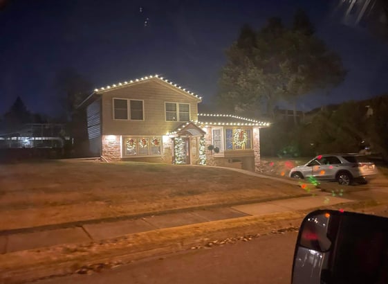 a house with christmas lights on a street