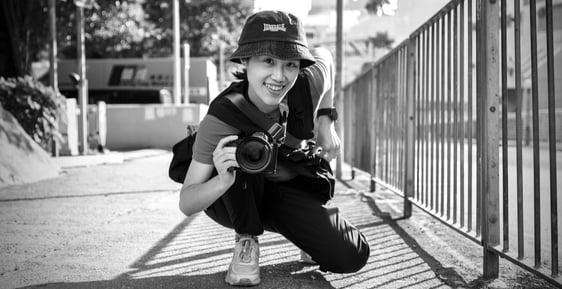 Young female street photographer with camera 