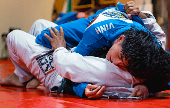 Photo d'un sparring avec deux combattants dont l'un est en position montée