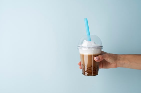a person holding a cup of coffee in their hand