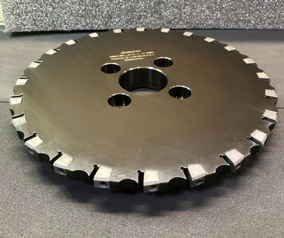 a circular saw blade saw blade sawdusted on a table
