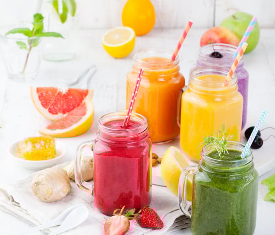 a variety of smoothie drinks in a variety of colors