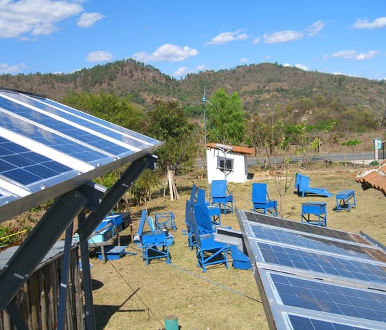 image of field of solar ovens with solar PV modules in the fore ground at the Centro Solar