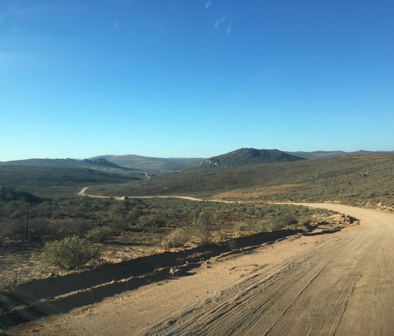 winding dirt road overlooking hills