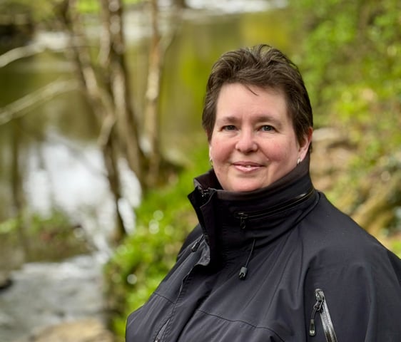 Karen Webster, freelance Proofreader and copy editor, looking at the camera on hike in Wales