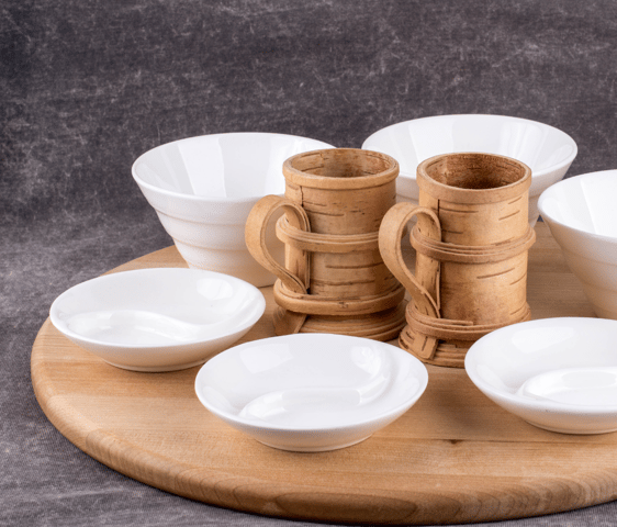 Art of kitchen designer made bowls and water mugs made of bamboo wood placed on a round wood plate