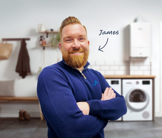 James Athey, owner and founder of JA Plumbing & Heating, standing in front of a new boiler