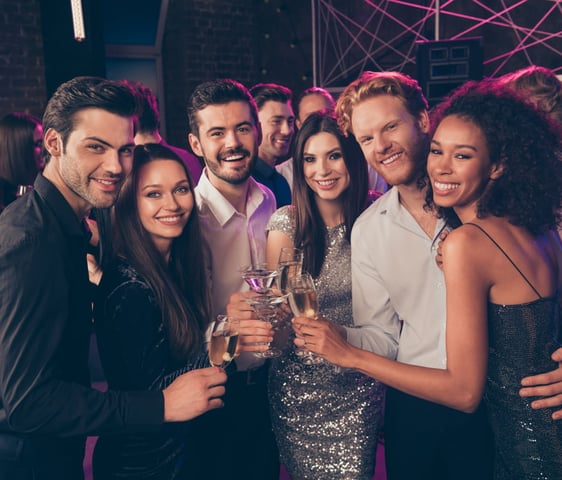 Stylish group of friends enjoying champagne and cocktails at an upscale downtown Las Vegas nightlife venue.