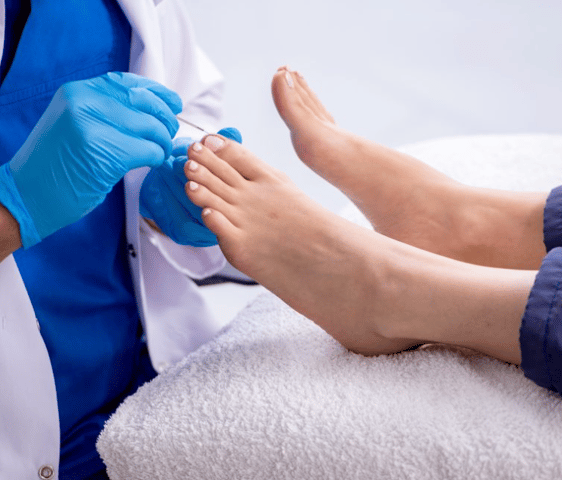 Foot Nurse with a patient's foot in home