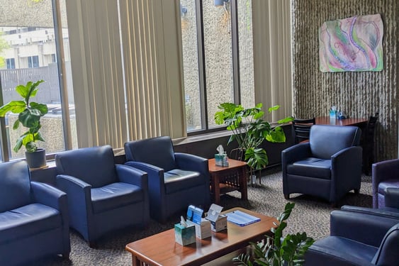 our in-person peer support group room with comfortable chairs, art, and plants