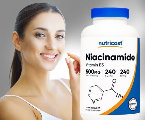 a woman holding a bottle of vitamin supplements