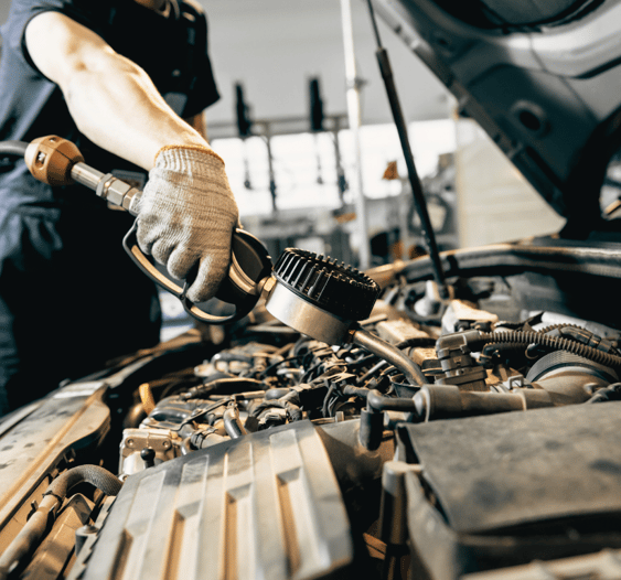 Mechanic adding fluids under the hood for optimal car performance