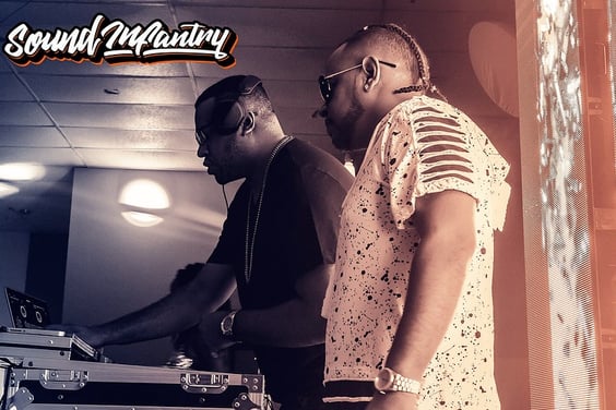a man in a white shirt and sunglasses is playing with a dj