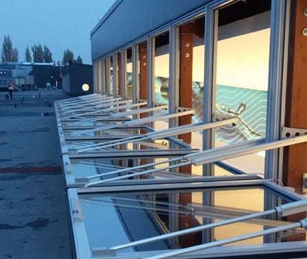 a row of windows with a view of a beach