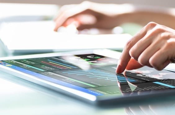 A woman working with a dashboard on a tablet