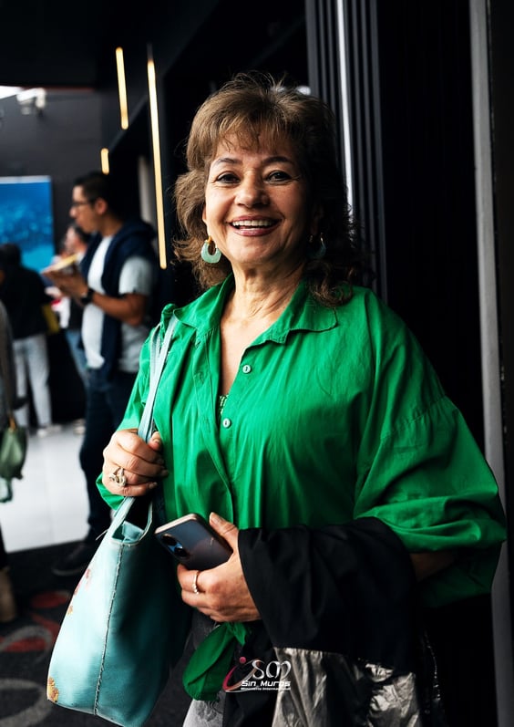 a woman in a green shirt and a green purse