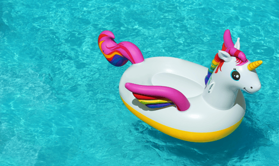 a unicorn floatie in the water with a rainbow - colored floatie