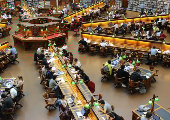 a large room with a lot of people sitting at tables