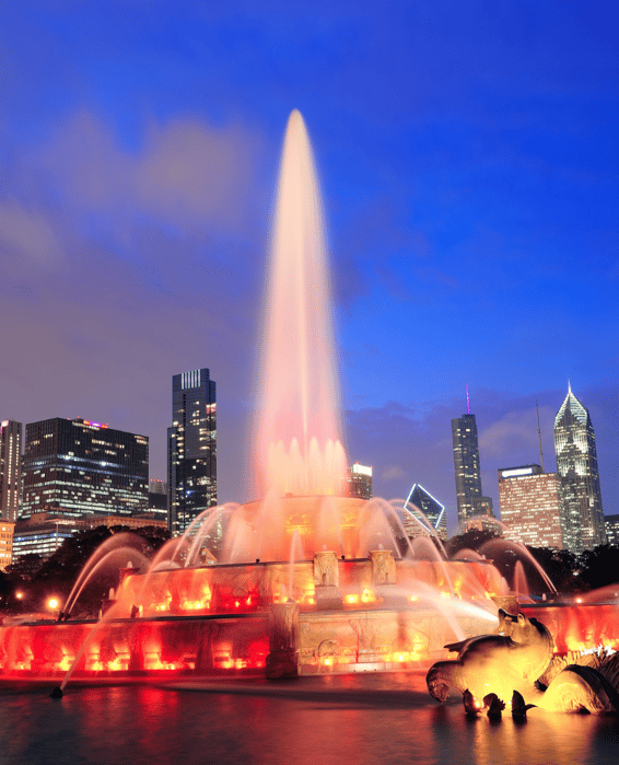 a fountain fountain with a city skyline in the background