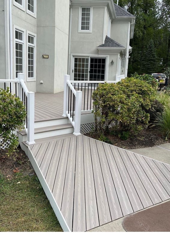 a white house with a white railing and a white railing