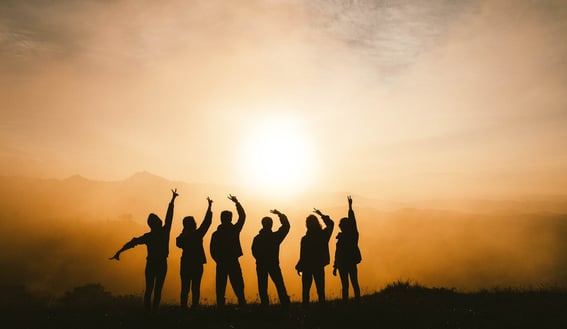a group of people standing on a hill top