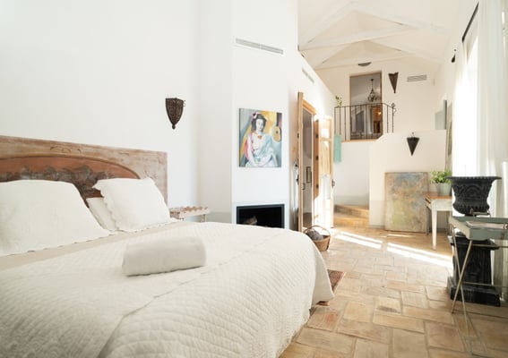 Charming rustic bedroom with art pieces at Finca Santa Katerina